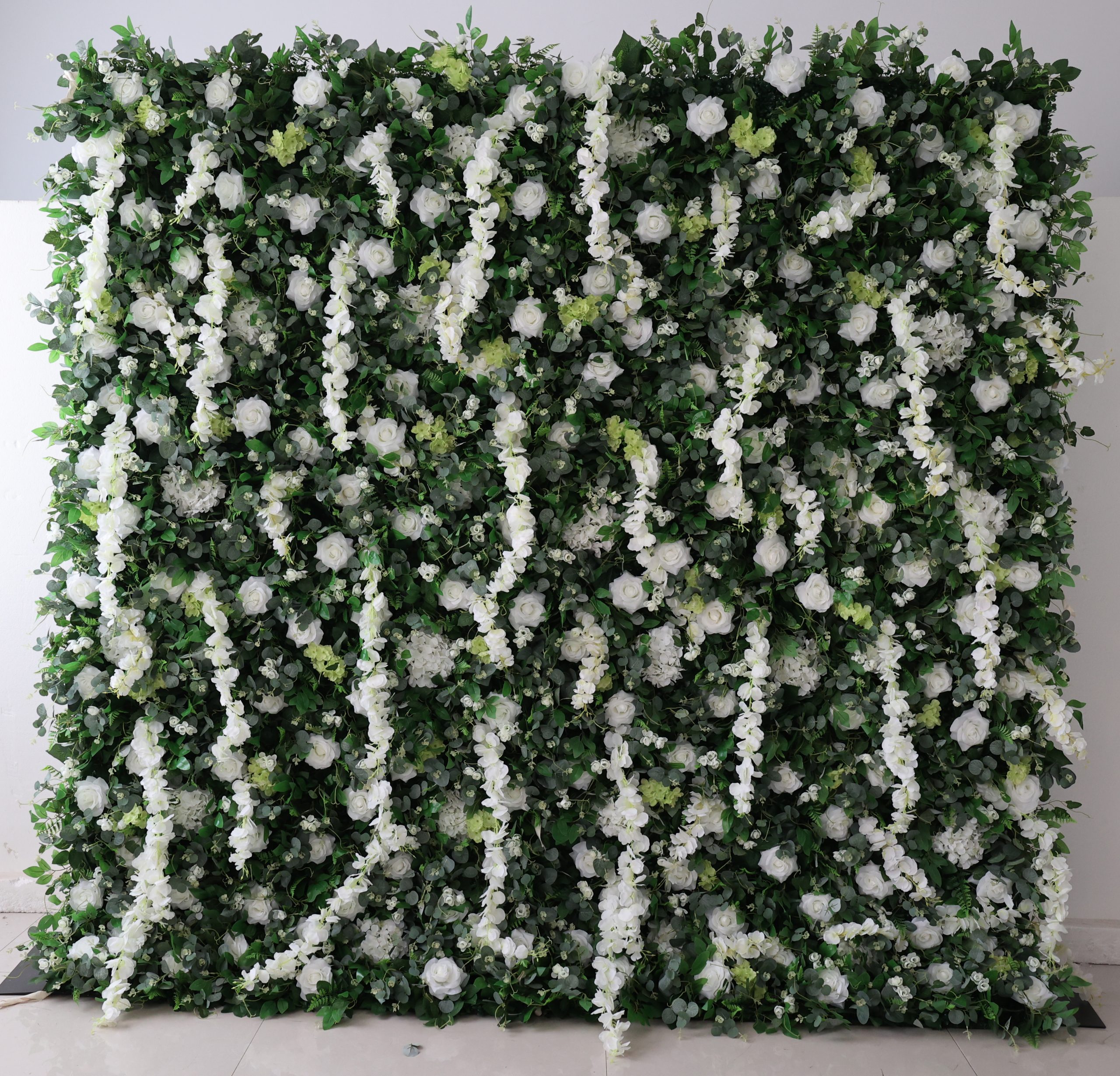 Lush green flower wall rentals with white roses and blooms