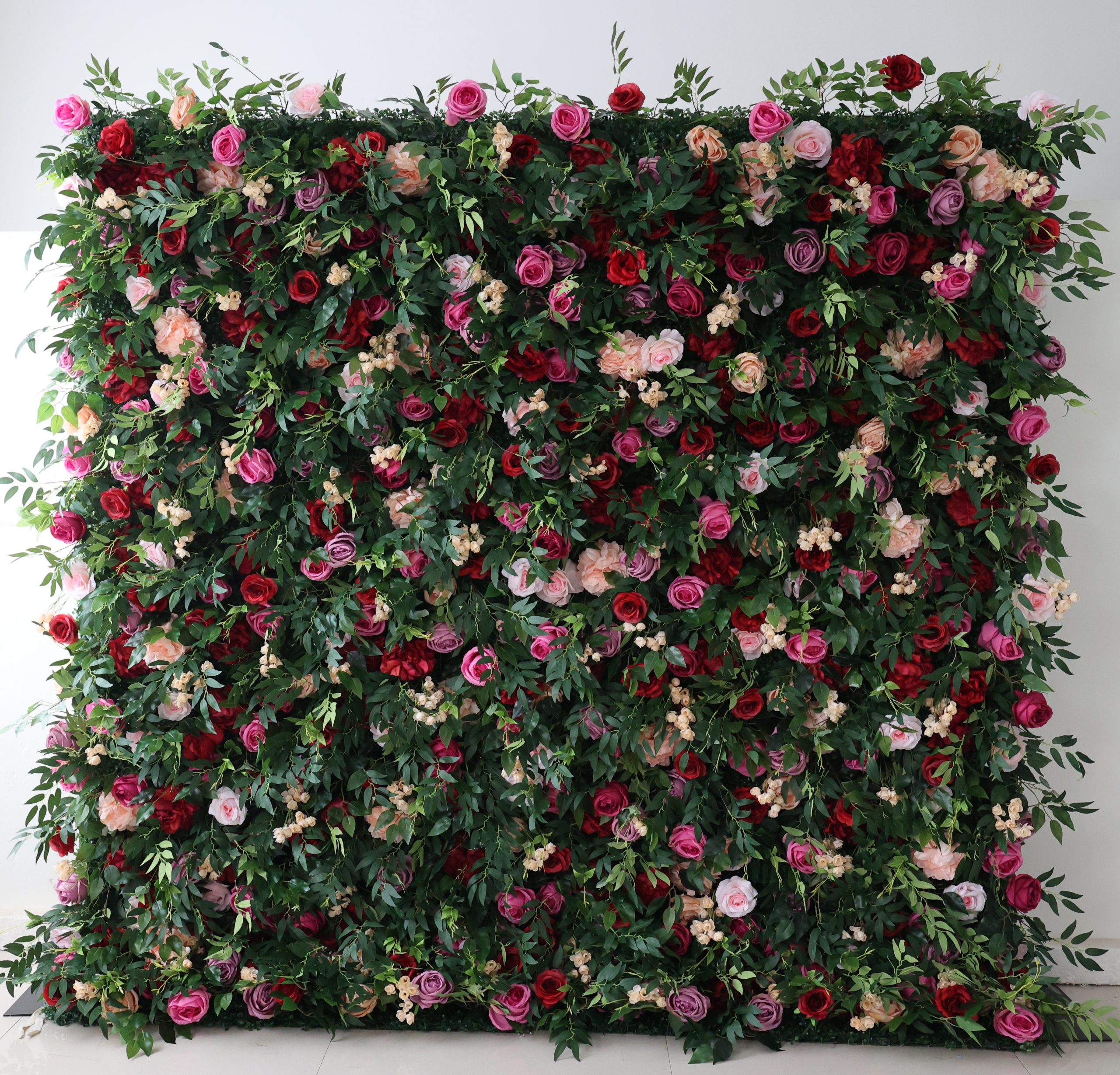 Flower Wall rental with different colored roses inside foliage