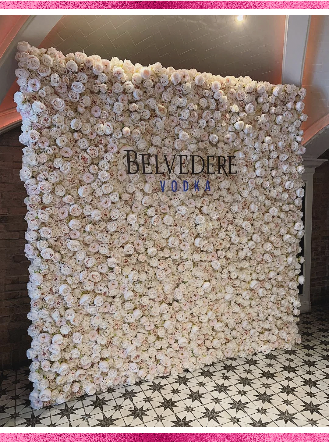 corporate flower wall rental with custom acrylic sign