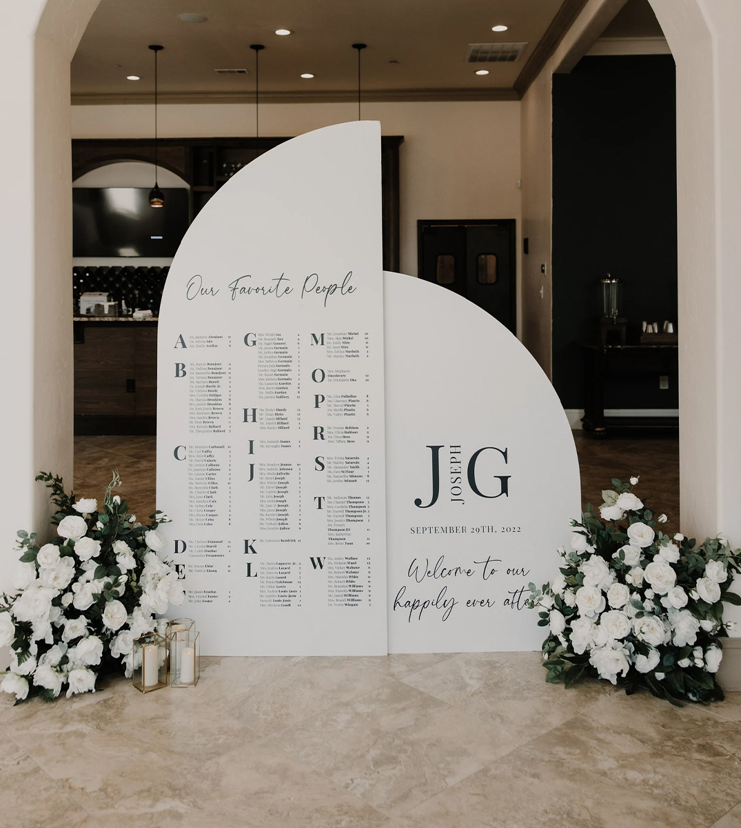 Custom acrylic sign in the form of a seating chart with floral pieces